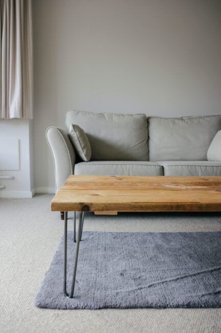 brown wooden table beside white coach