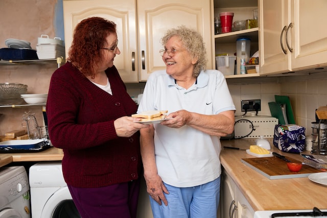 two women standing in kitchen