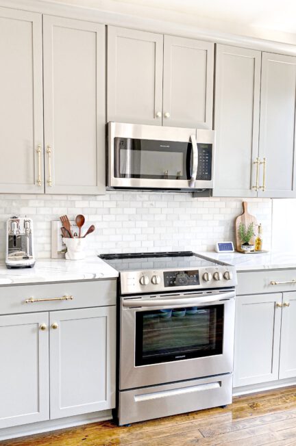 white microwave oven on white wooden cabinet