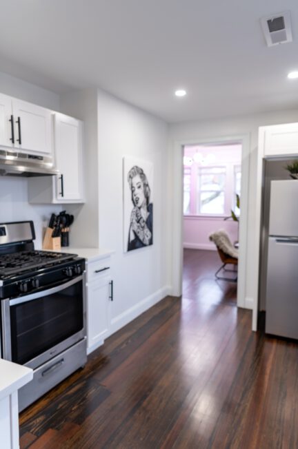 white top mount refrigerator beside white wooden kitchen cabinet