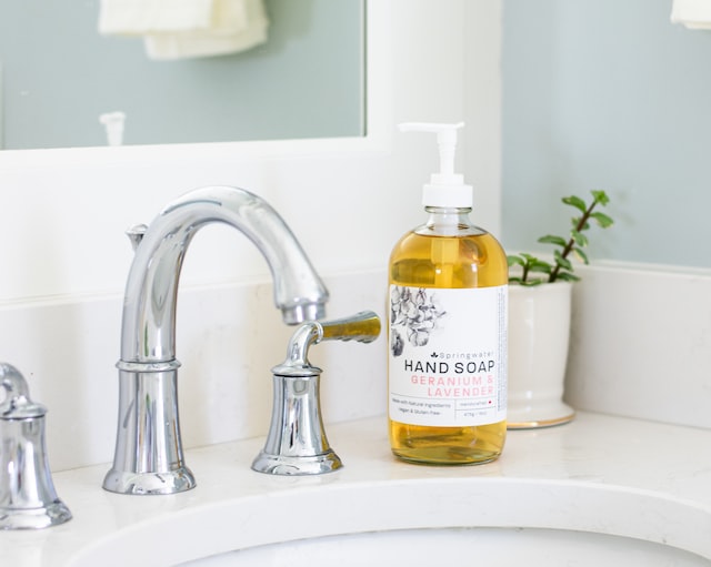 yellow plastic bottle on white ceramic sink